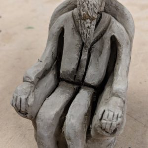 Sculpture of a man sitting in a chair