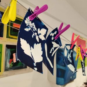 Images made with leaves and paint pegged on a line